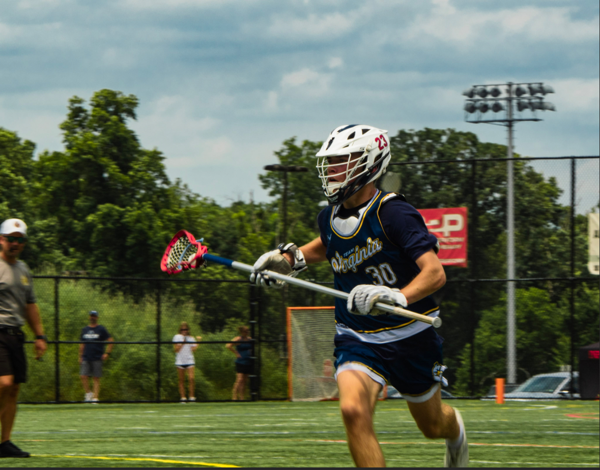 Team Virginia player #23 running with the ball in a navy game jersey